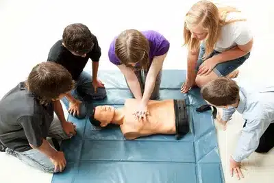 Trainees perform on a mannequin in an Ohio CPR Training